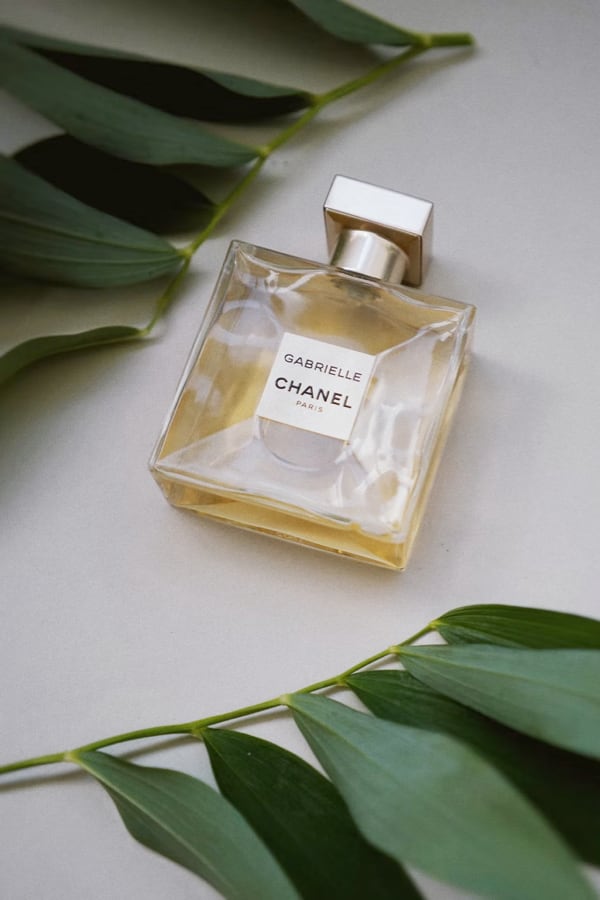 perfume on a table with leaves